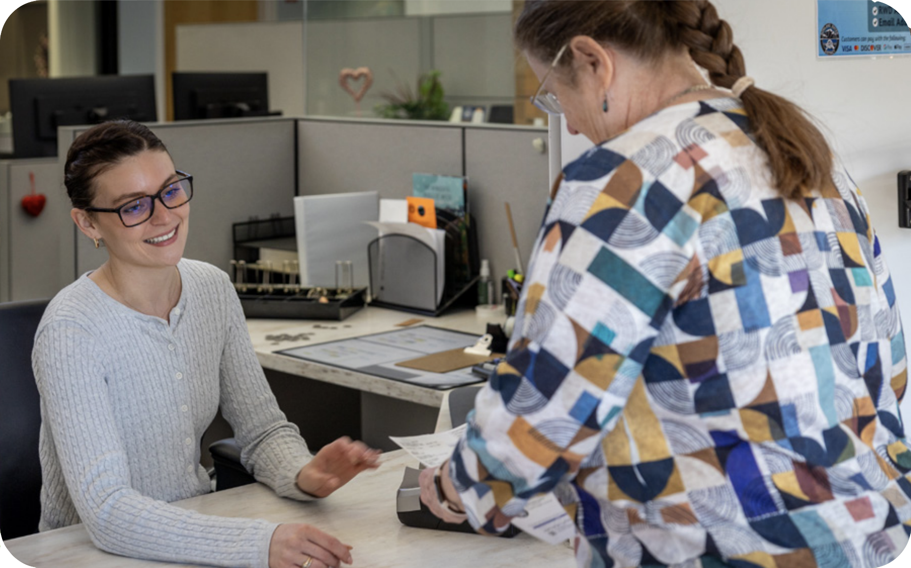Receptionist helping a woman